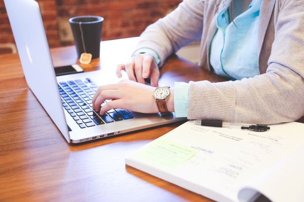 Woman typing on laptop at her desk